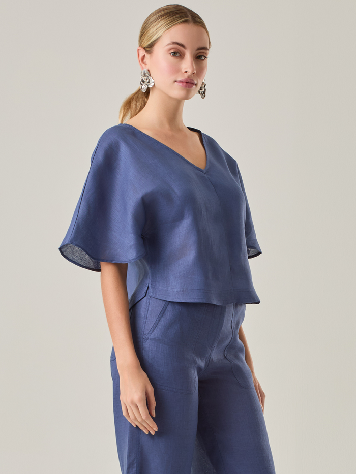 Blusa elegante con escote en V y mangas holgadas 3/4, su diseño es perfecto para utilizar con pantalones o faldas a tono.