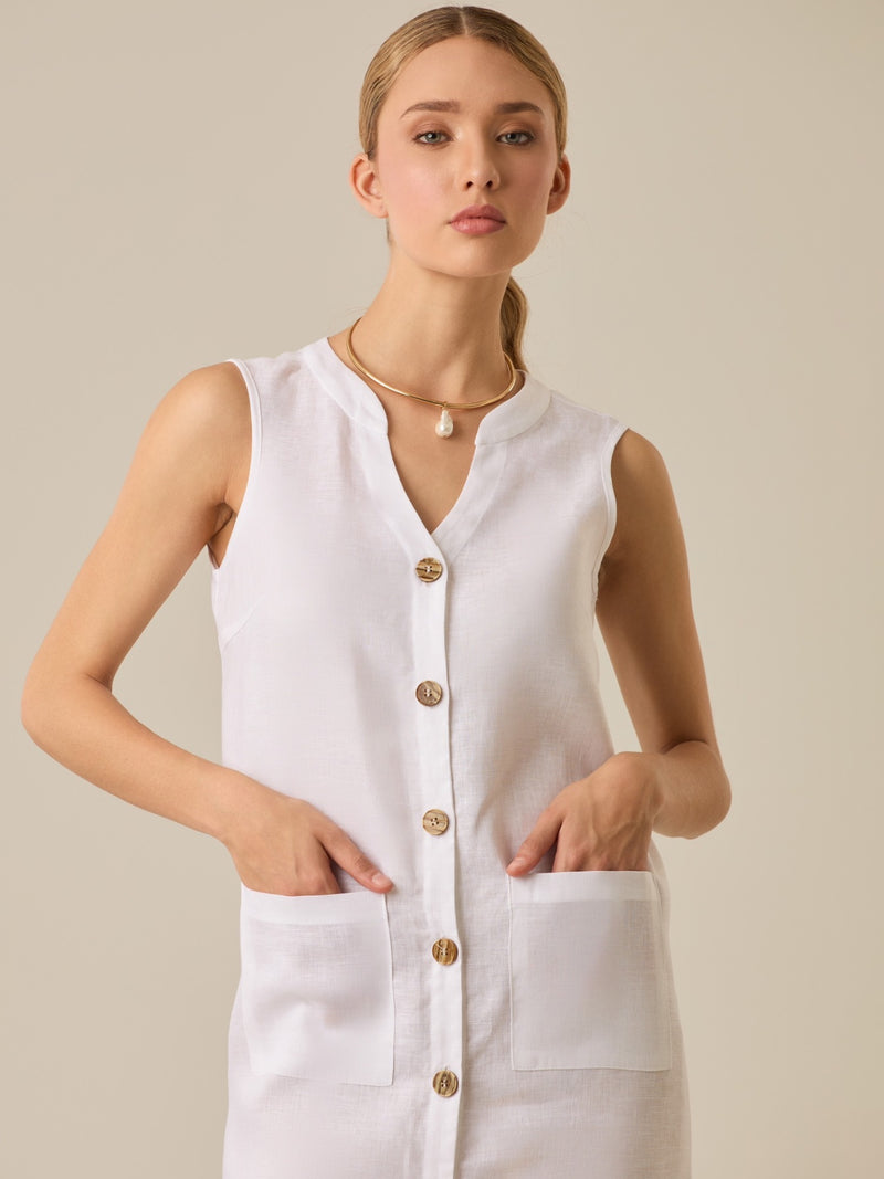 Vestido largo de lino con diseño elegante y funcional , diseño con  botones delanteros, bolsillos a la cadera y un cuello redondo que se complementa con un sutil escote en V, es ideal para un look  sofisticado y cómodo.